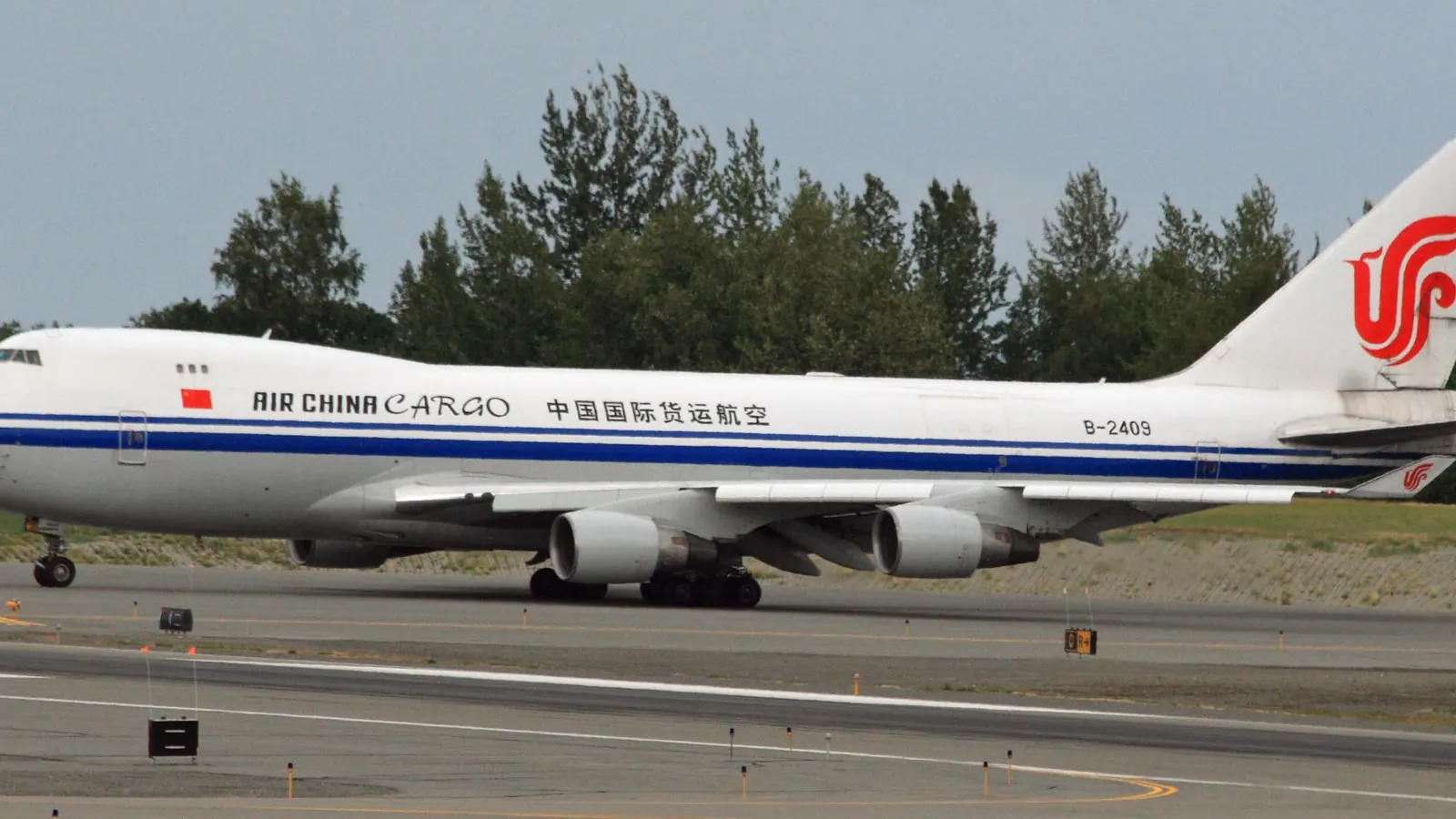 Boeing 747 freighter taxiing on a runway, air freight for urgent shipments