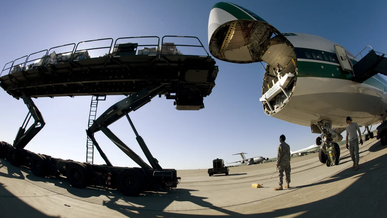 Cargo aircraft with its nose door open beside a loader, illustrating air waybill vs bill of lading in air and sea freight