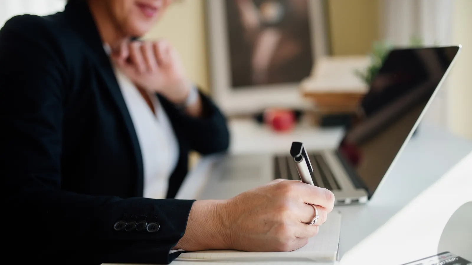 Business professional working at a laptop and reviewing payment terms