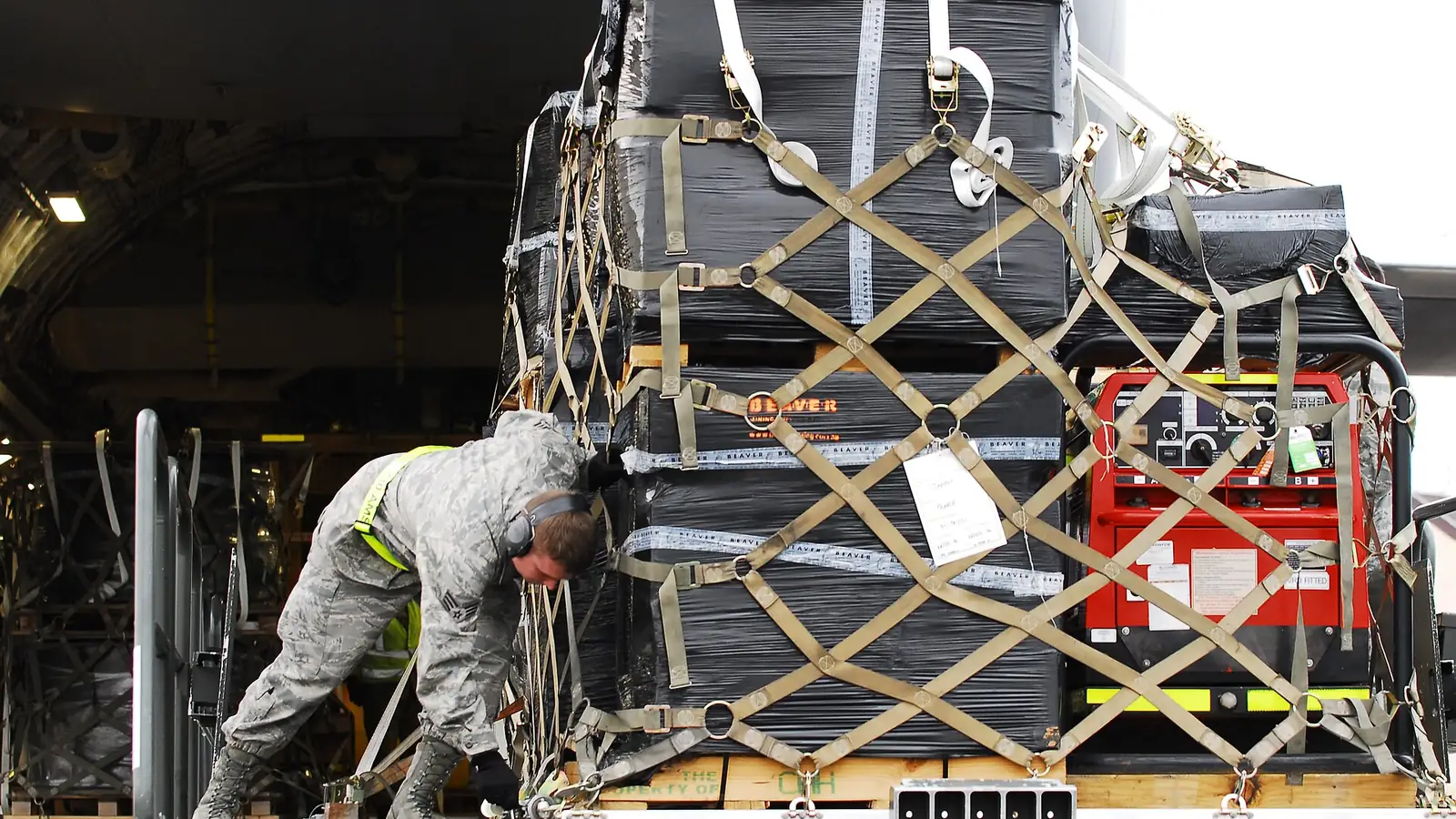 Cargo pallet wrapped in a net being loaded onto an aircraft, an example of cargo volume measured in CBM calculation