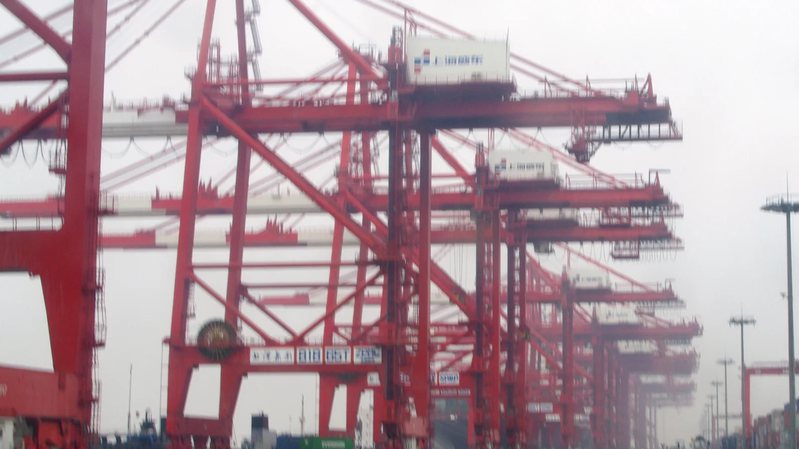 Container terminal cranes and stacked containers at a Chinese port, the kind of cargo flow that slows around Chinese New Year 2027 for importers
