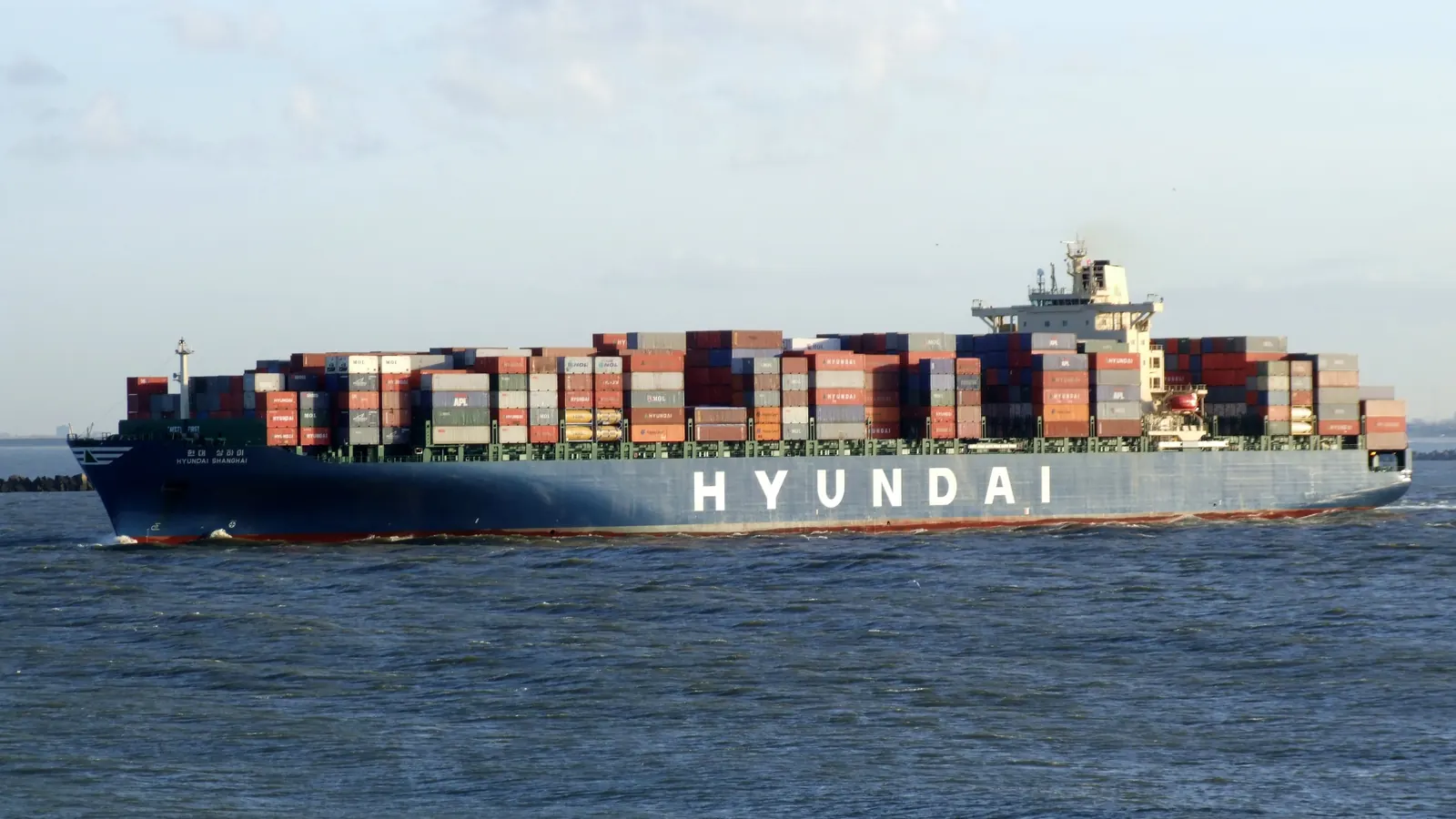 Container ship loaded with containers leaving a port, sea freight from China