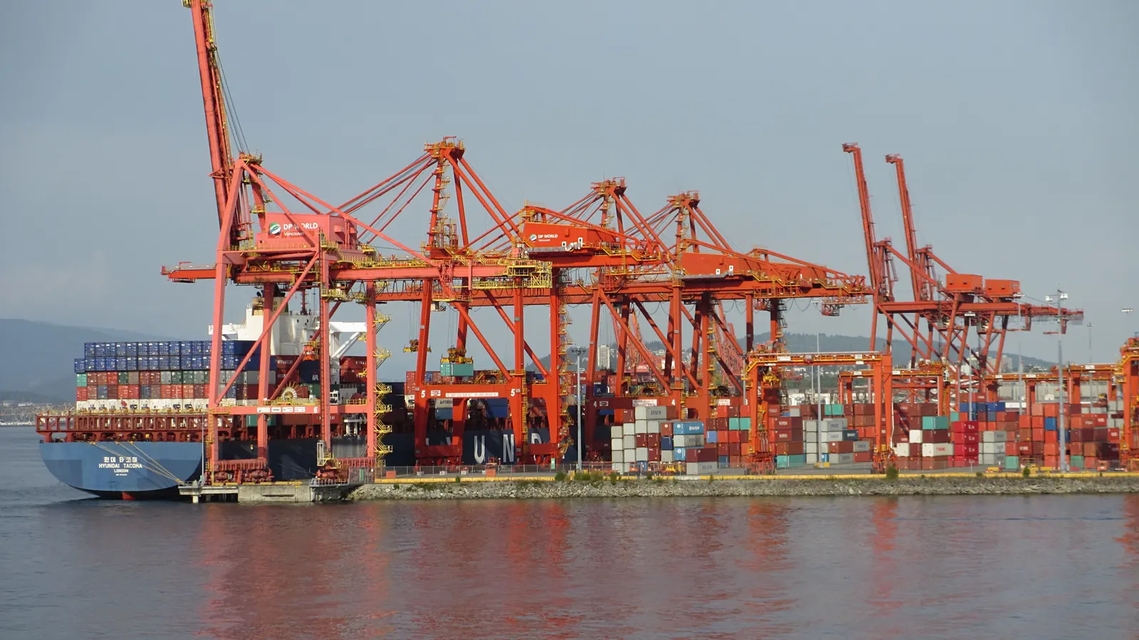 Container terminal with orange quay cranes where imported goods are cleared and duty is assessed