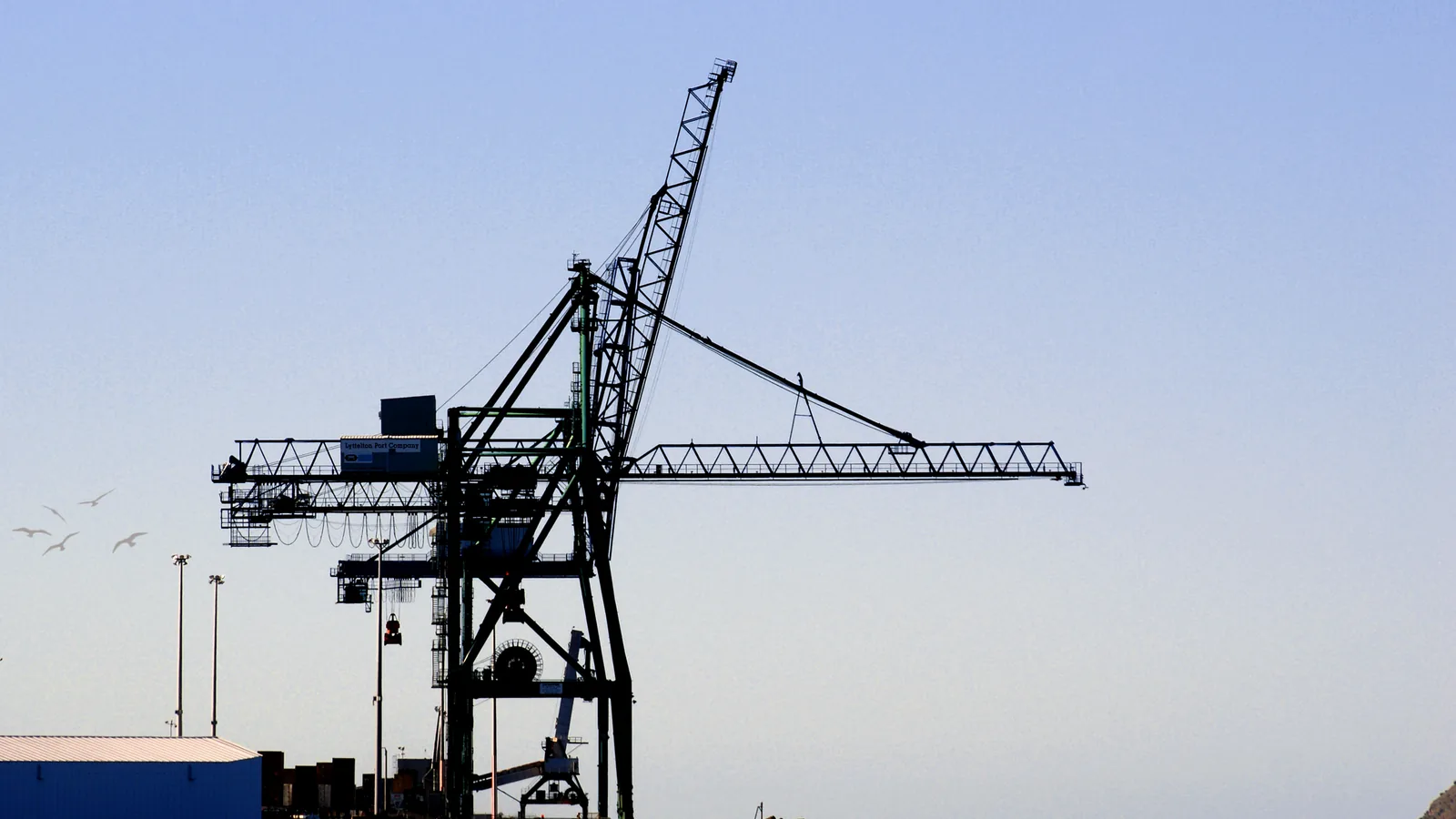 Container terminal crane against the sky, the kind of port equipment that handles cargo moving under UAE CEPA agreements